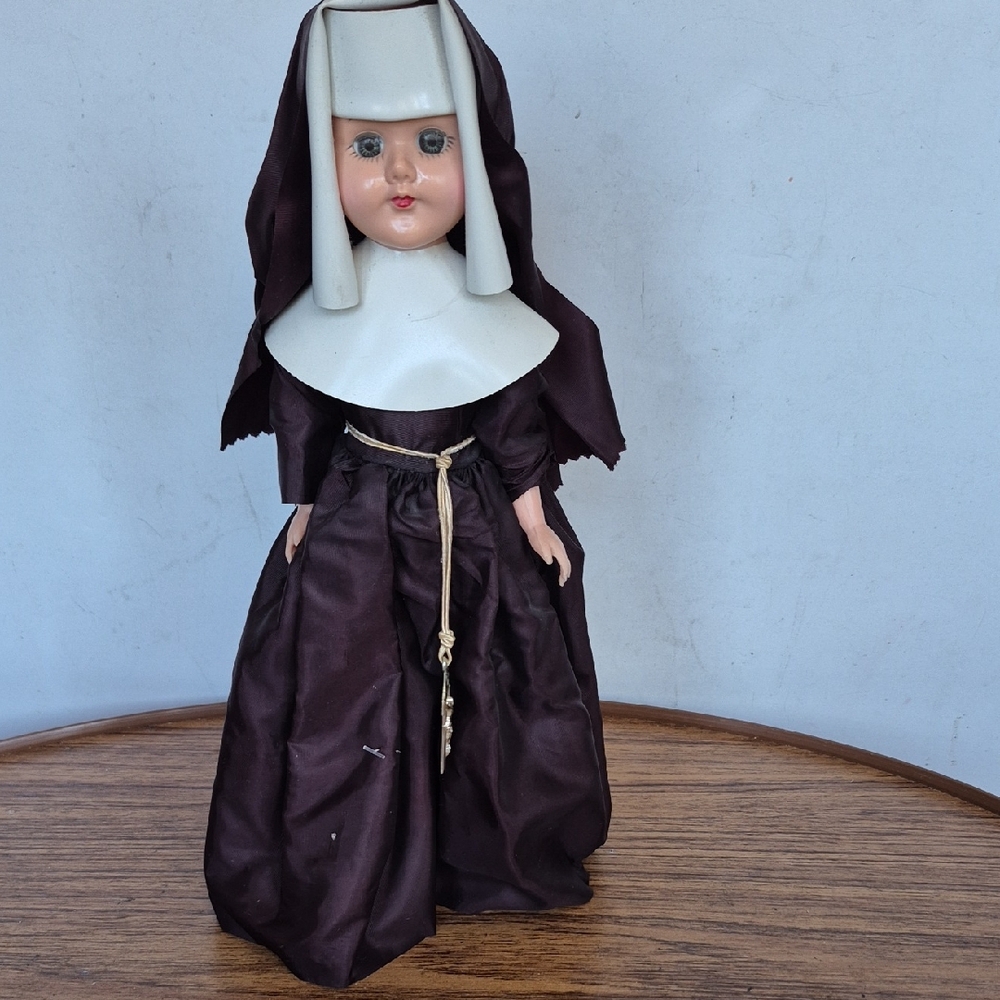 Elegant  Vintage Nun Doll with Brown and White Attire Gently Displayed.